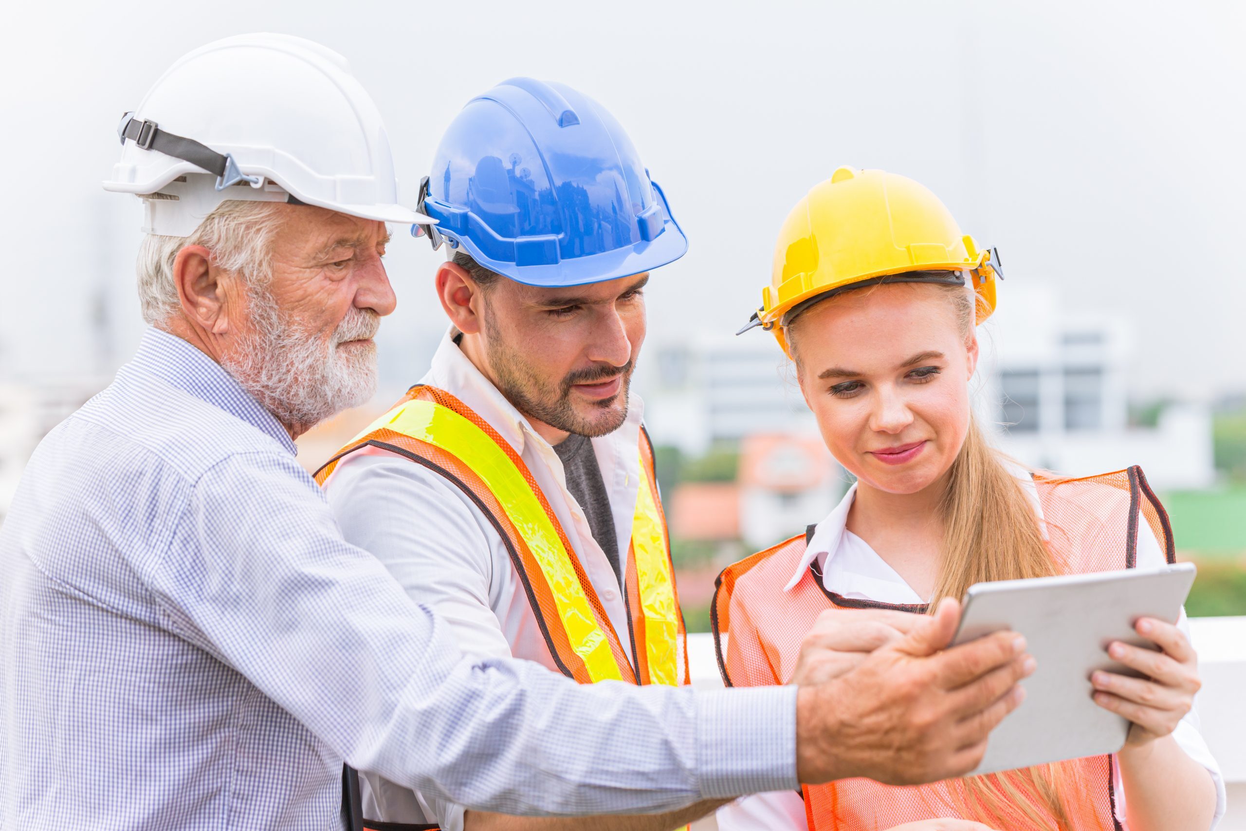 group of builder engineer and architecture using new technology of tablet for inspect building design working join together