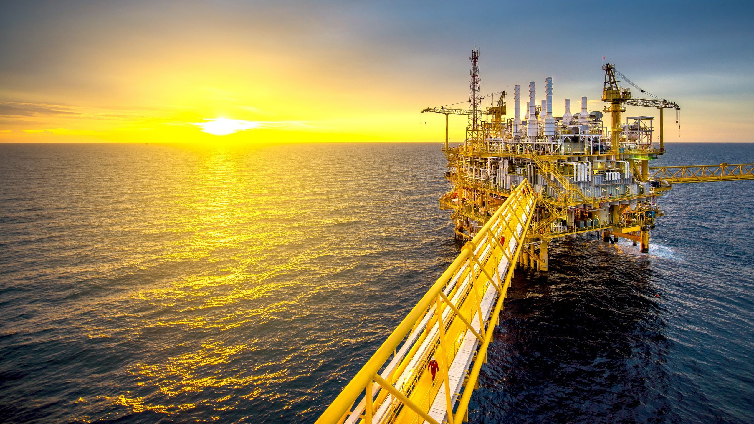 Large Offshore oil rig drilling platform at sunset and beautiful sky in the gulf of Thailand