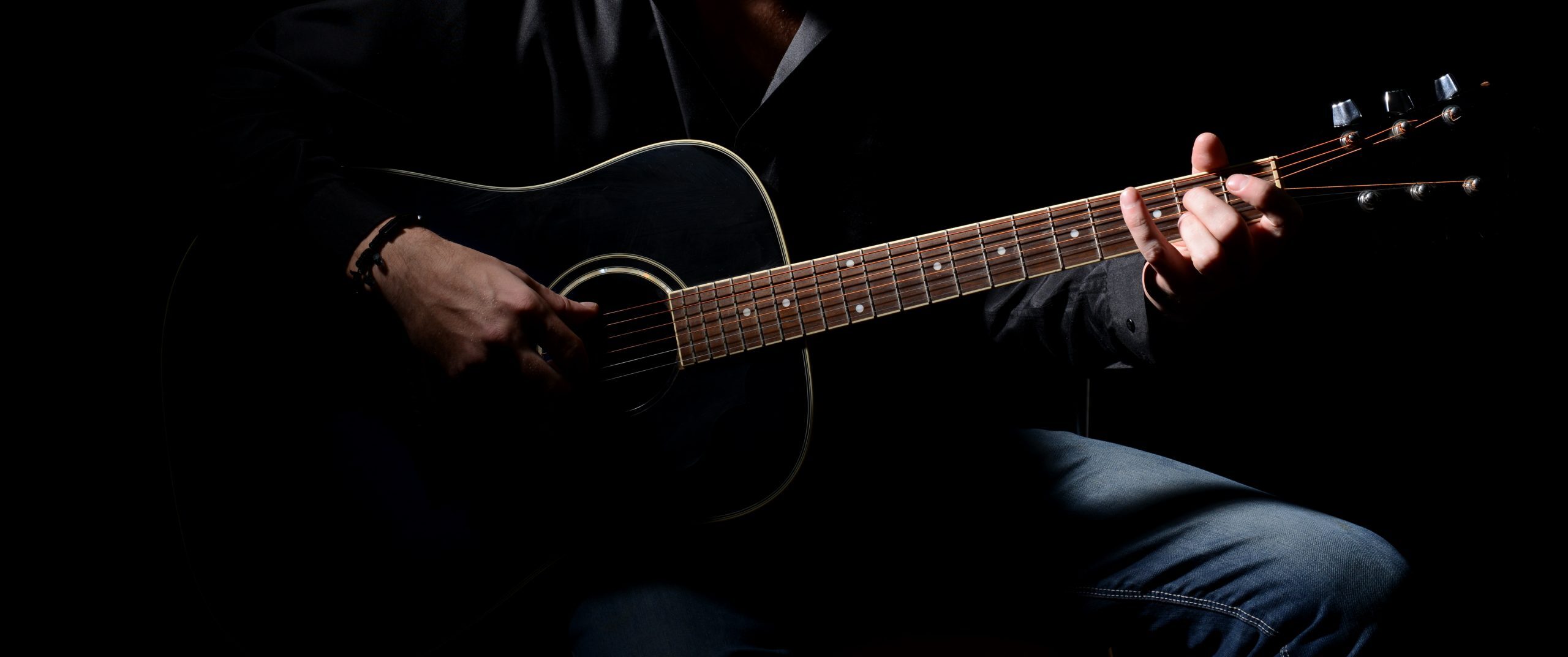 Young musician playing acoustic guitar and singing,